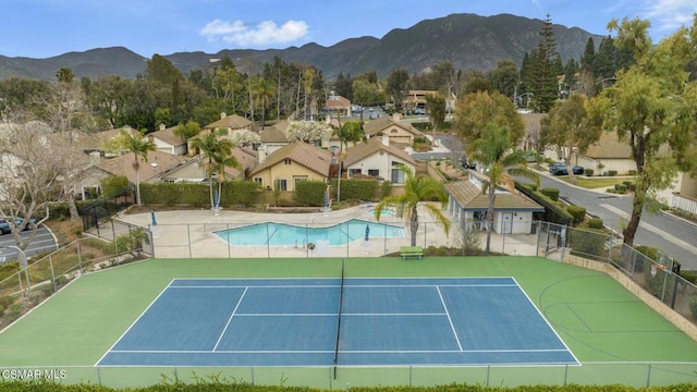 view of tennis court with a mountain view