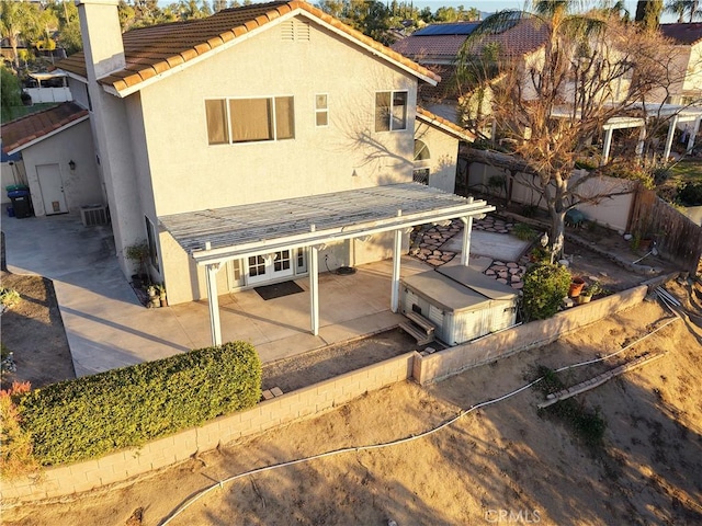 rear view of property with central AC unit and a patio area