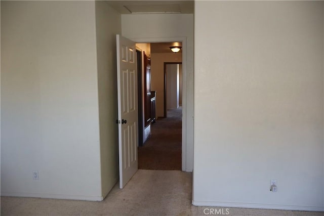 hall featuring light colored carpet