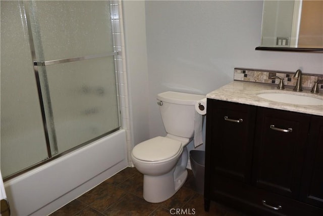 full bathroom with vanity, combined bath / shower with glass door, and toilet