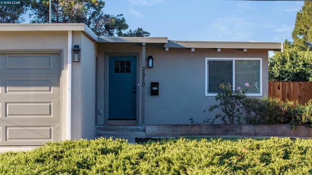 view of exterior entry with a garage