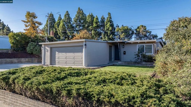 ranch-style house with a garage and a front yard