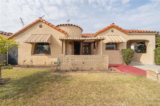 mediterranean / spanish-style house with a front lawn