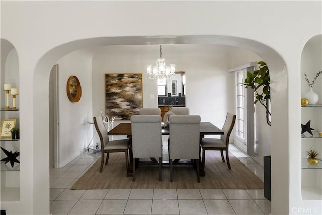 tiled dining area with a chandelier