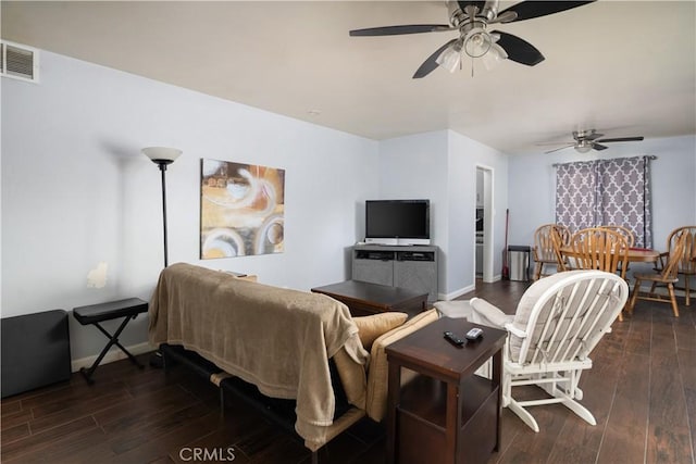 living room featuring dark wood-type flooring and ceiling fan