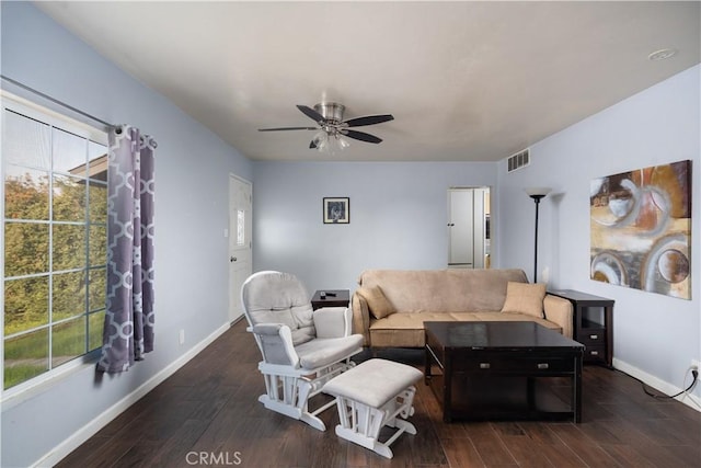 living room featuring dark hardwood / wood-style flooring, a wealth of natural light, and ceiling fan