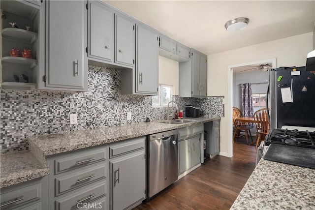 kitchen with dark wood-type flooring, stainless steel appliances, gray cabinets, and sink