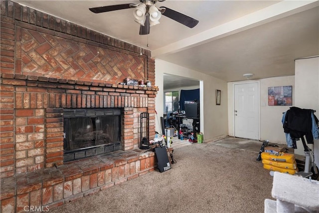 carpeted living room with a brick fireplace and ceiling fan