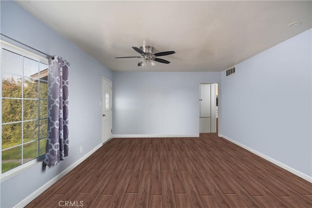 spare room featuring dark hardwood / wood-style floors and ceiling fan