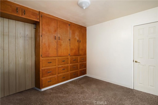 unfurnished bedroom featuring dark carpet