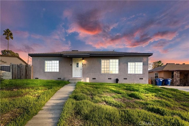 view of front of property with a lawn