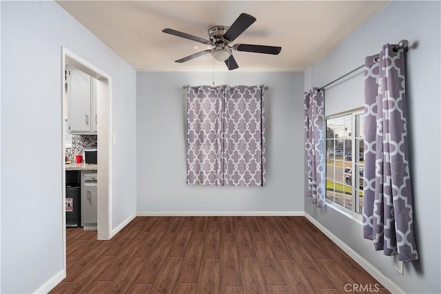 empty room featuring ceiling fan and dark hardwood / wood-style flooring