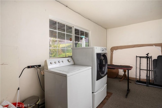 washroom with washer and clothes dryer and dark colored carpet