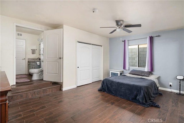 bedroom featuring ceiling fan, ensuite bathroom, dark hardwood / wood-style flooring, and a closet