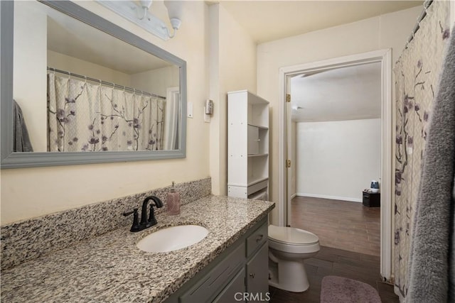 bathroom with vanity, toilet, and wood-type flooring