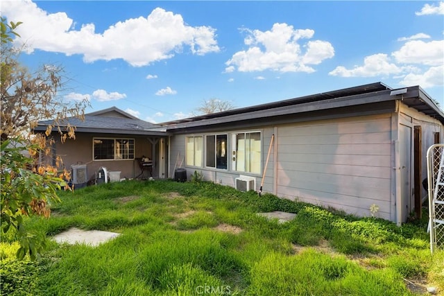 back of house featuring cooling unit