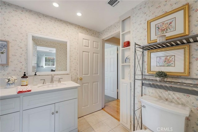 bathroom featuring vanity, toilet, and tile patterned flooring