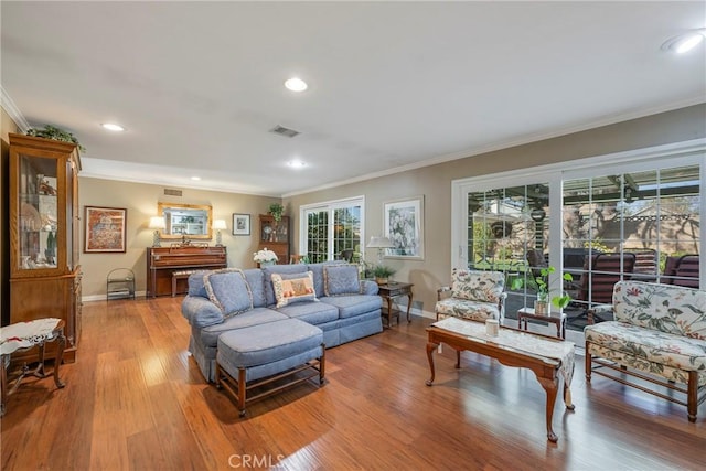 living room featuring hardwood / wood-style flooring and ornamental molding