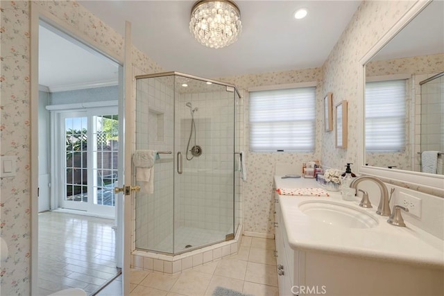 bathroom with walk in shower, tile patterned floors, vanity, and crown molding