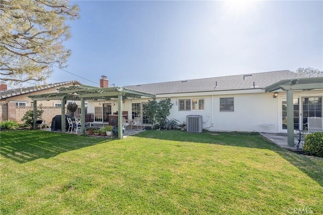 rear view of property with central AC, a yard, a pergola, and a patio area