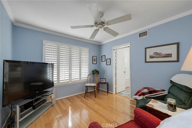 living room with crown molding, ceiling fan, and wood-type flooring