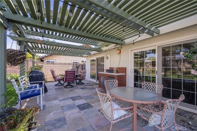 view of patio / terrace with area for grilling and a pergola