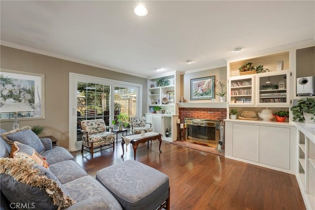 living room featuring crown molding, dark wood-type flooring, and a brick fireplace