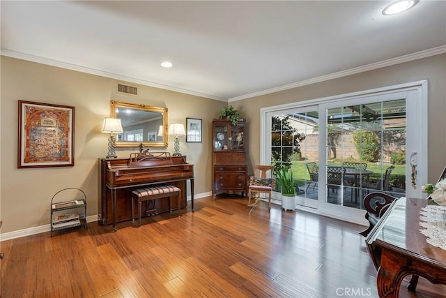 misc room with ornamental molding and hardwood / wood-style floors