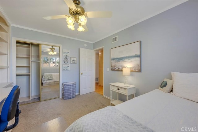 bedroom with light carpet, ornamental molding, a closet, and ceiling fan