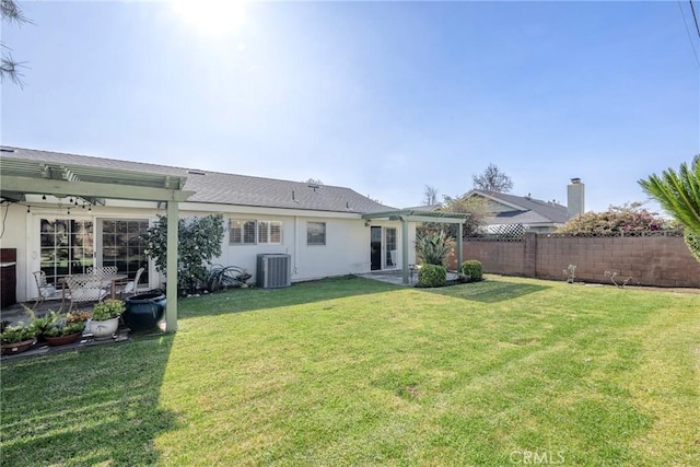 rear view of house with cooling unit, a yard, and a pergola