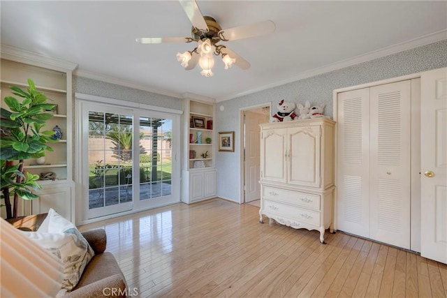 sitting room with light hardwood / wood-style flooring, ornamental molding, and ceiling fan