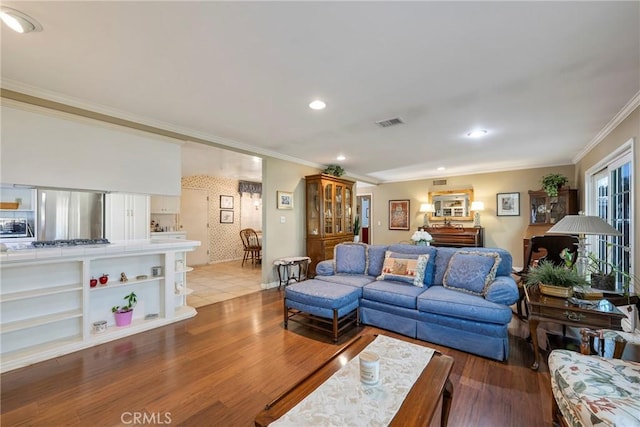 living room featuring hardwood / wood-style floors and ornamental molding