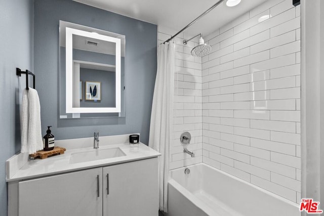 bathroom featuring vanity and shower / tub combo with curtain