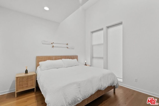 bedroom with hardwood / wood-style flooring