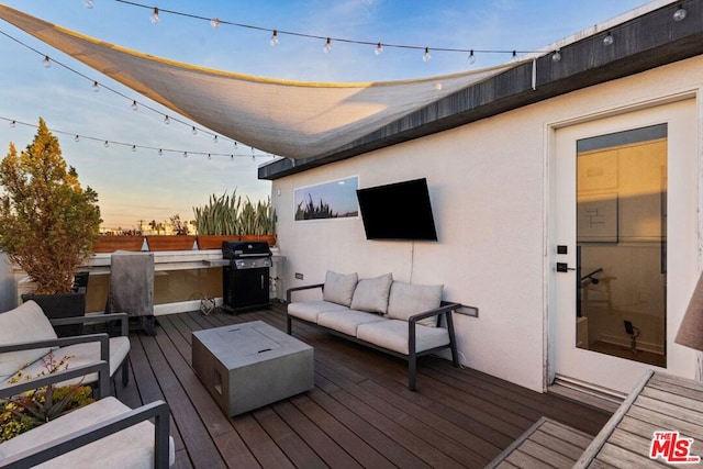 deck featuring an outdoor living space and a grill