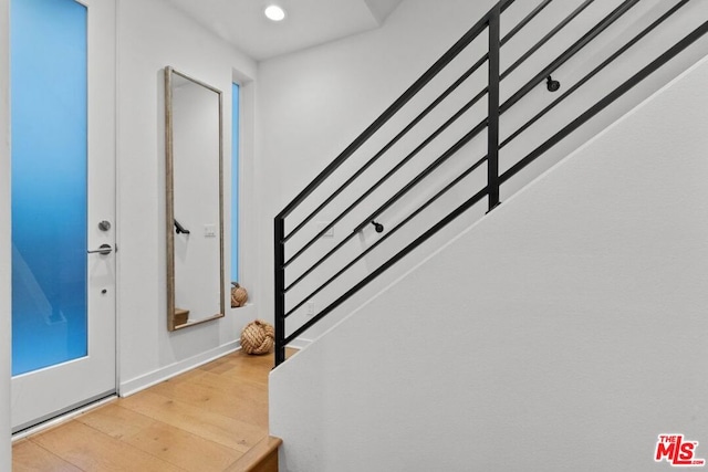 entryway with hardwood / wood-style flooring