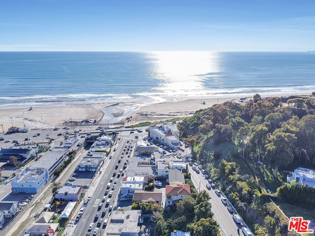 aerial view with a water view and a view of the beach