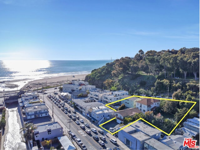 bird's eye view featuring a water view and a view of the beach