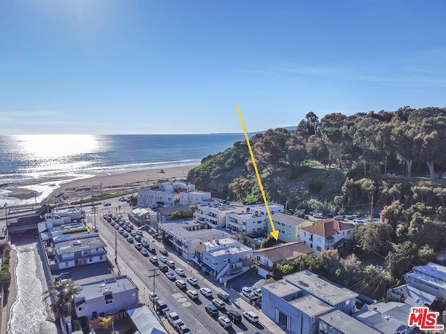 drone / aerial view featuring a water view and a beach view