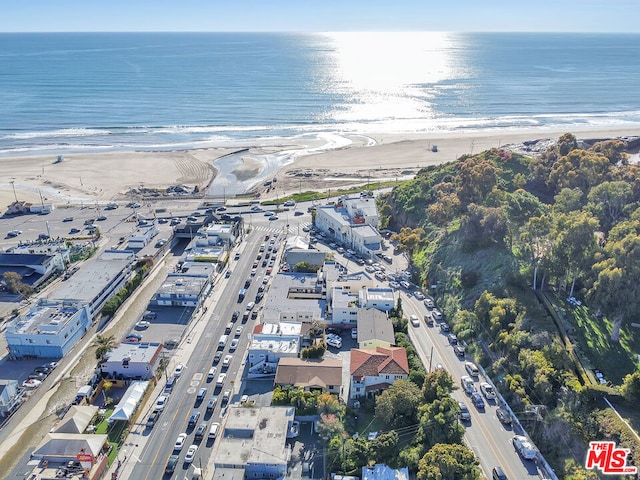 birds eye view of property featuring a water view and a view of the beach