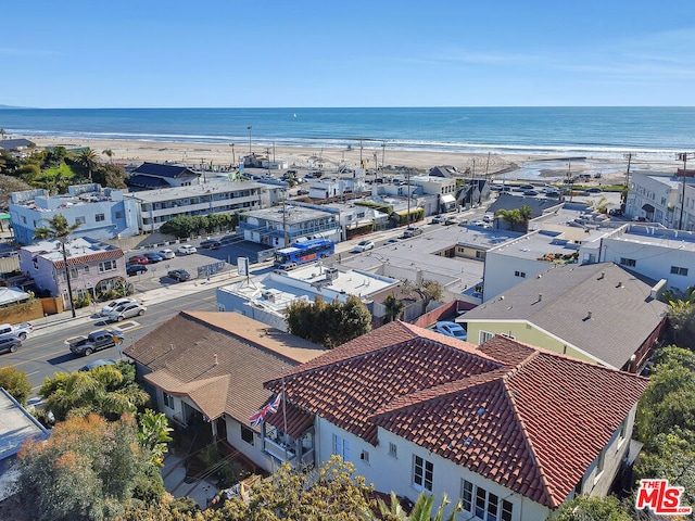 birds eye view of property with a view of the beach and a water view