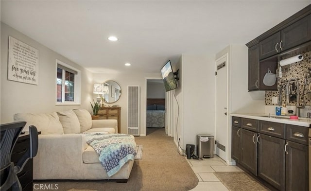 tiled living room featuring sink