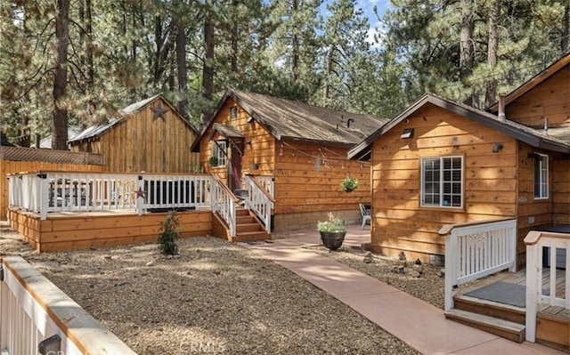 rear view of house with a wooden deck