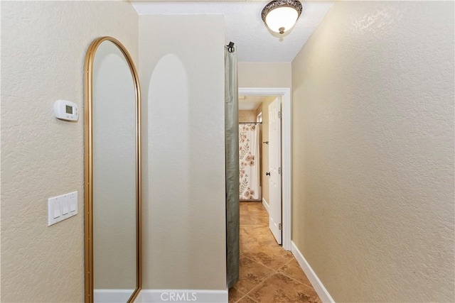 corridor featuring light tile patterned flooring