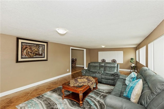 living room with tile patterned floors and a textured ceiling