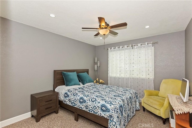 bedroom featuring ceiling fan and carpet