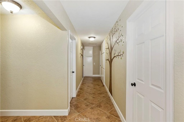 hall with light tile patterned floors