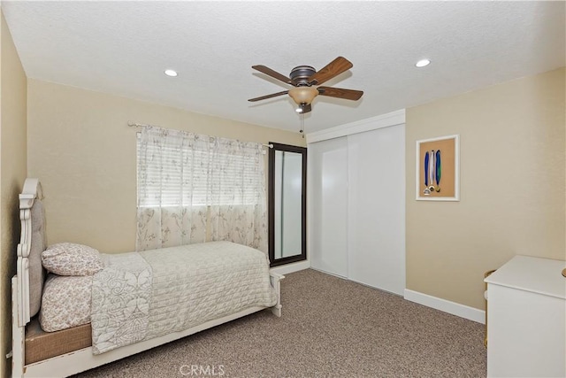 bedroom featuring ceiling fan, a closet, and carpet