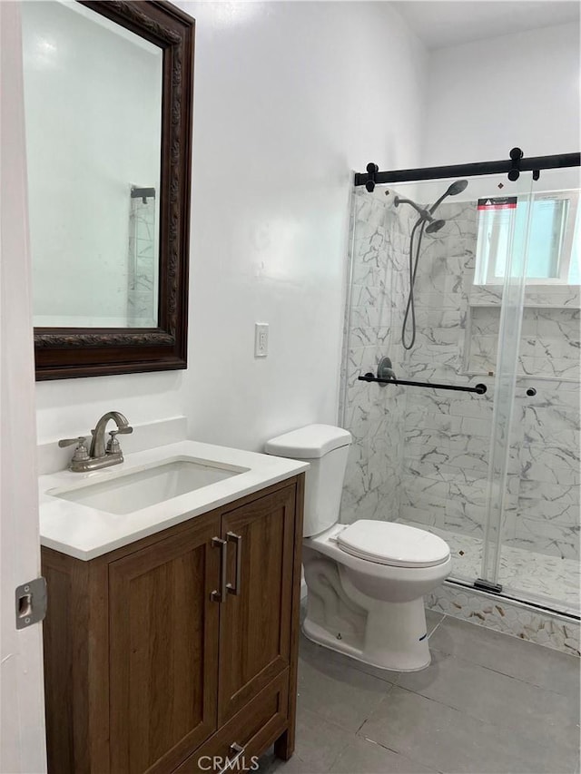 bathroom featuring vanity, toilet, tile patterned flooring, and a shower with door