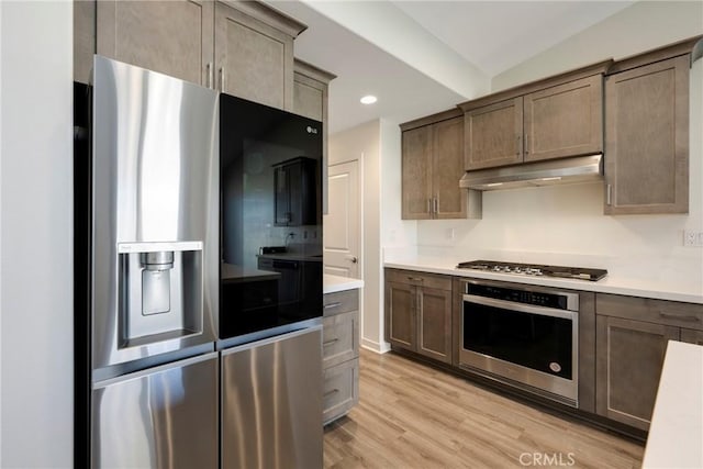 kitchen featuring appliances with stainless steel finishes and light hardwood / wood-style flooring